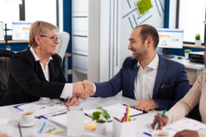 consultant-greeting-international-client-with-handshake-after-partnership.jpg